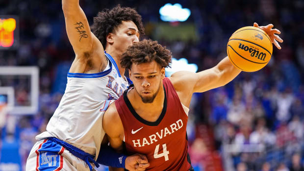 Dec 22, 2022; Lawrence, Kansas, USA; Harvard Crimson forward Chris Ledlum (4) drives against Kansas Jayhawks forward Jalen Wilson (10) during the first half at Allen Fieldhouse.